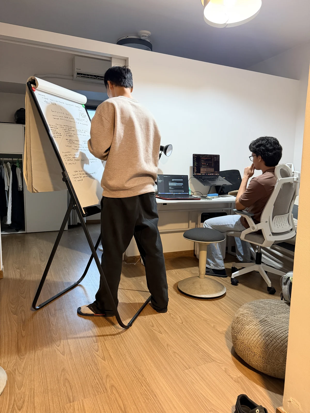 A software planning session with a whiteboard and laptops